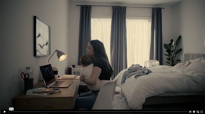 Female with a child next to a laptop