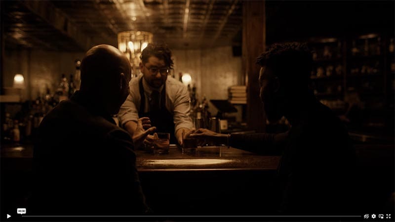 Barman pouring two drinks