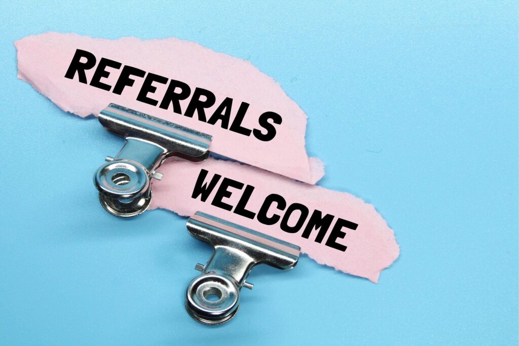 Clipboards with 'Referrals Welcome' sign